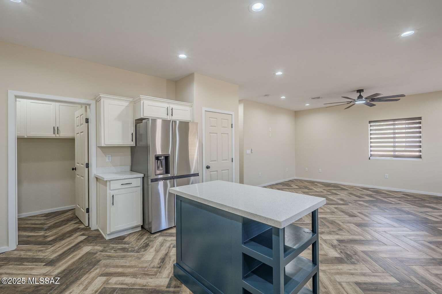 1796 Cajeme Court Rio Rico, AZ 85648 - Photo 12 of 45 a kitchen with a table and refrigerator