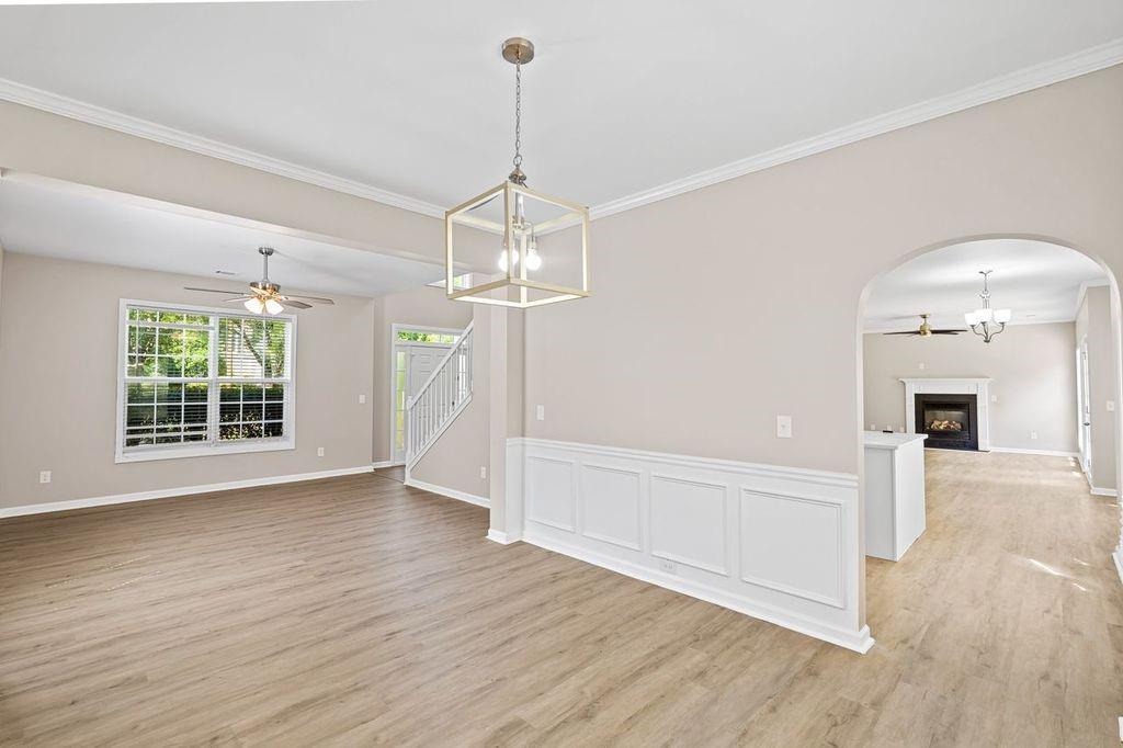473 Greyhawk Way Fairburn, GA 30213 - Photo 5 of 34 a view of an empty room with wooden floor and a window