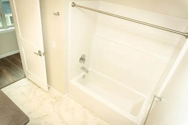 a bathroom with a bathtub and shower