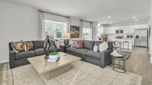 a living room with furniture a rug and a table
