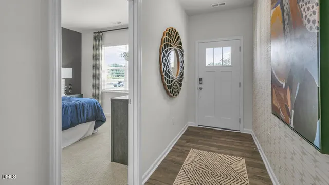 a view of a hallway to rooms