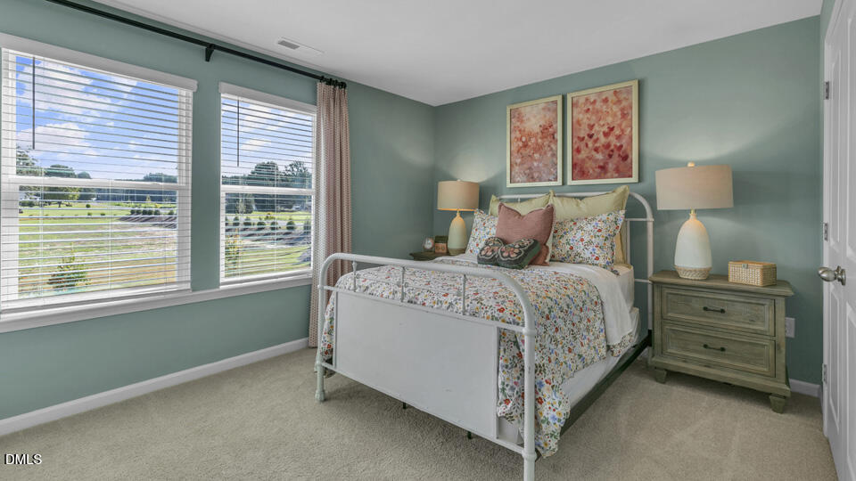 8 Tiger Eye Drive Clayton, NC 27520 - Photo 24 of 37 a bed sitting in a bedroom next to a window