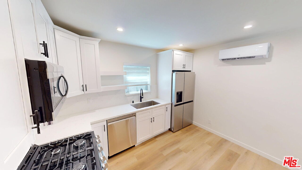 1305 Waterloo Street, Unit B Los Angeles, CA 90026 - Photo 3 of 9 a kitchen with a sink appliances and cabinets