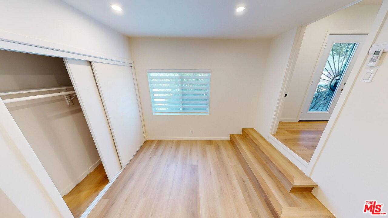 1305 Waterloo Street, Unit B Los Angeles, CA 90026 - Photo 9 of 9 a view of an empty room with wooden floor and a window