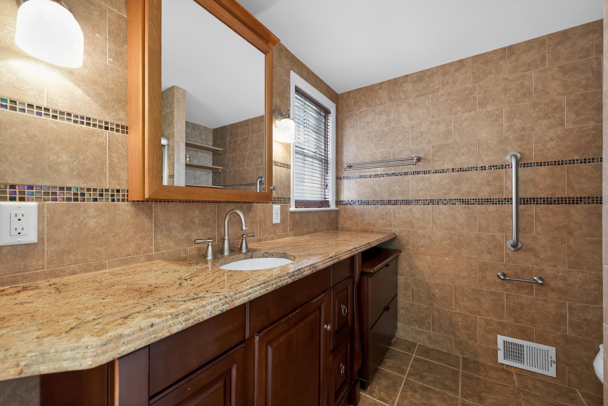 36 Decatur Road Havertown, PA 19083 - Photo 27 of 35 a bathroom with a granite countertop sink a mirror and shower