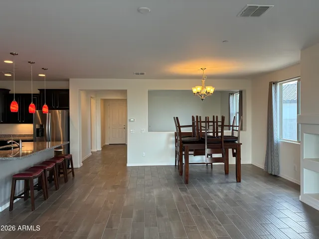 a view of a a dining room with furniture window and wooden floor