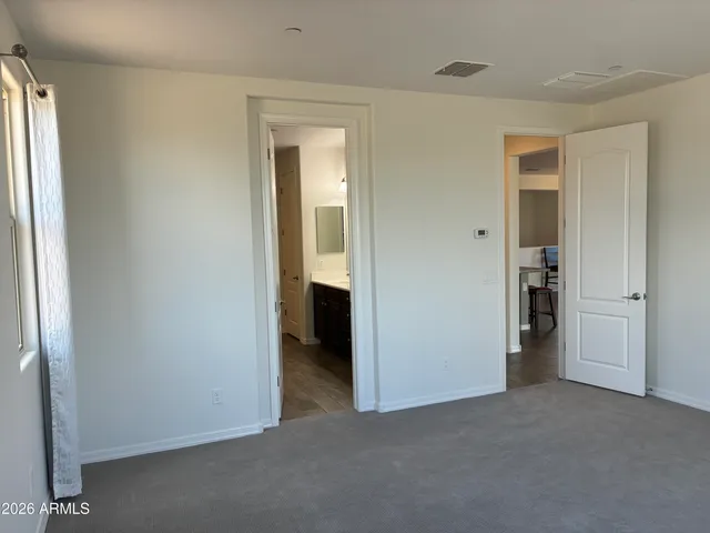 an empty room that has a grey walls
