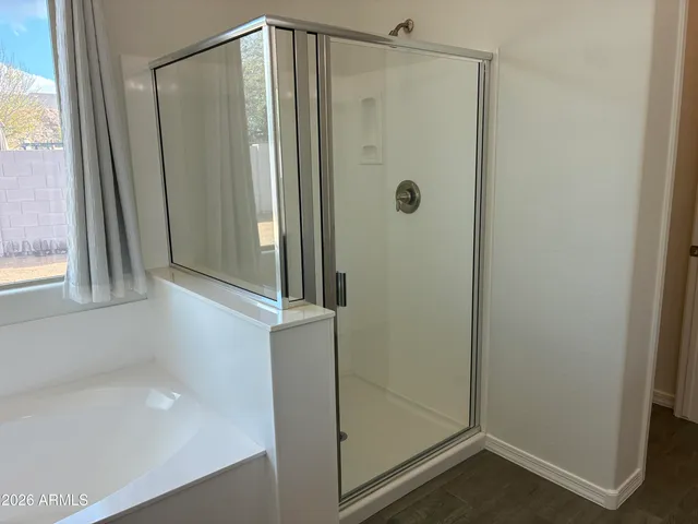 a bathroom with a glass shower door