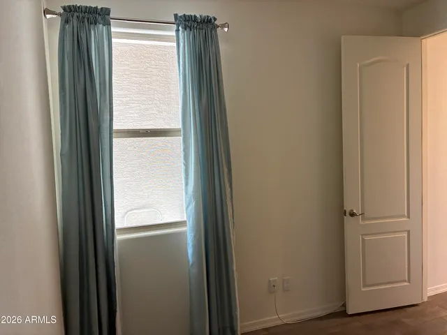 a view of a storage & utility room with refrigerator