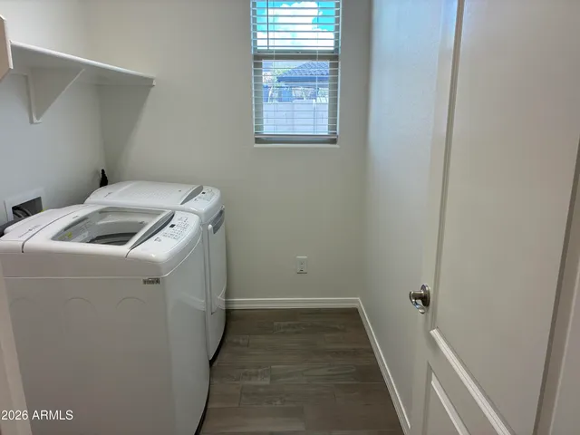 a view of a house with backyard and road
