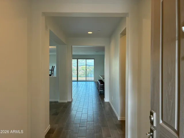 a view of a hallway with a livingroom and a bathroom with sink