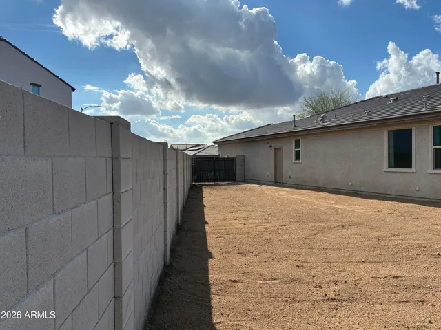 a view of a house with a wooden fence