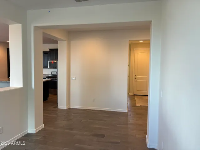 a view of a hallway with wooden shelves