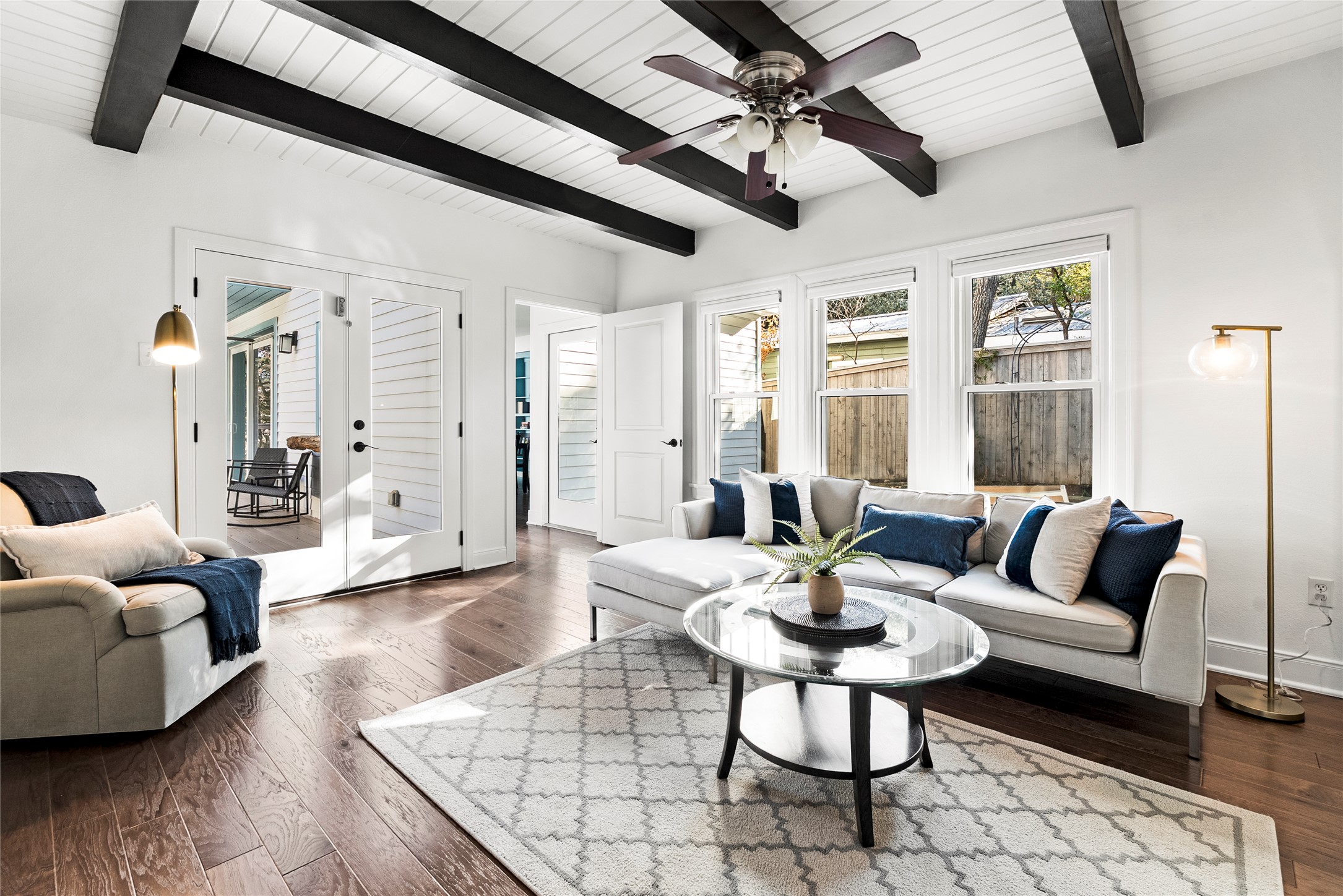 1507 Newning Avenue Austin, TX 78704 - Photo 11 of 37 Living area featuring dark wood-type flooring, french doors, a ceiling fan, and a wood ceiling with exposed beams