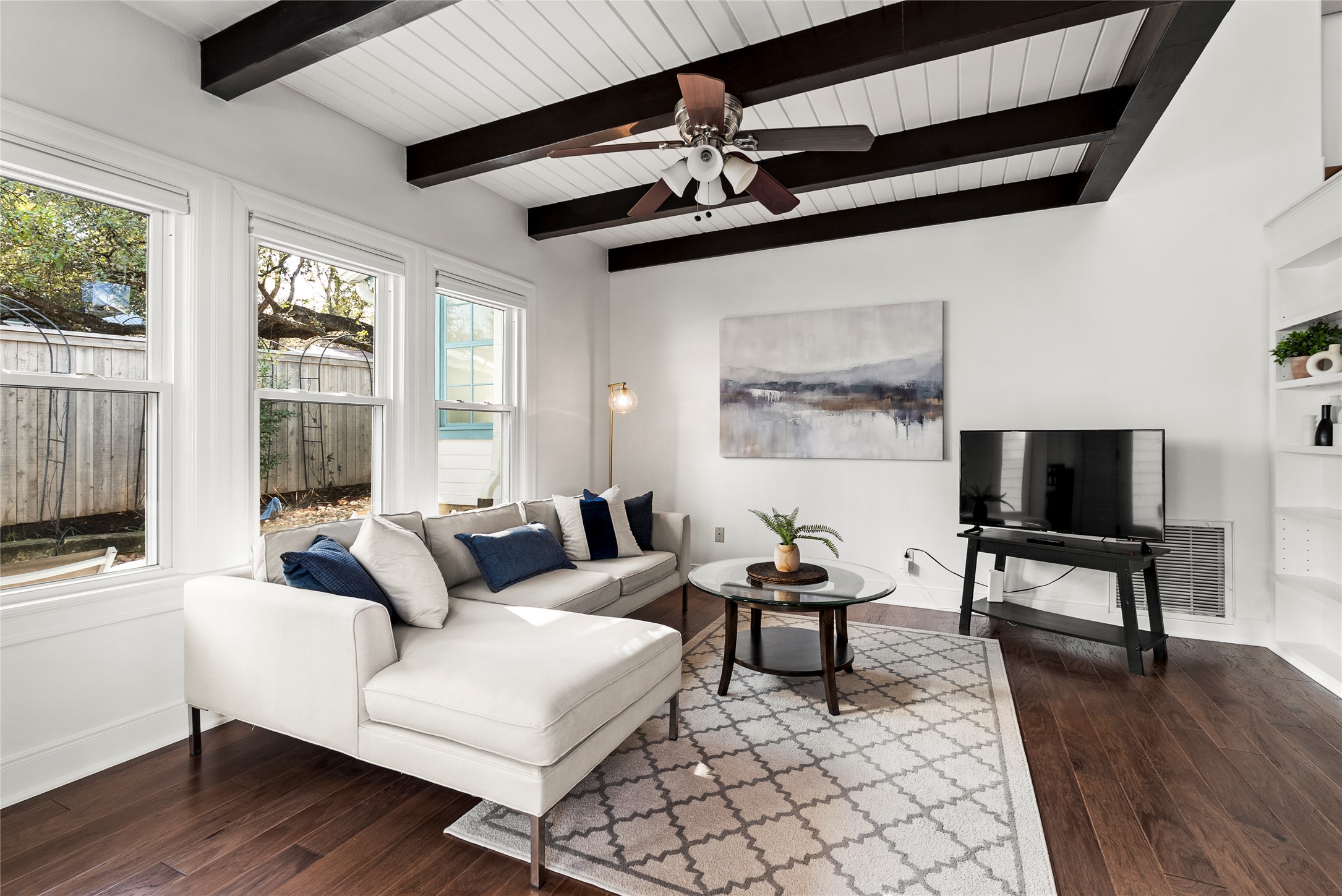 1507 Newning Avenue Austin, TX 78704 - Photo 12 of 37 Living area with ceiling fan, dark wood finished floors, and beam ceiling