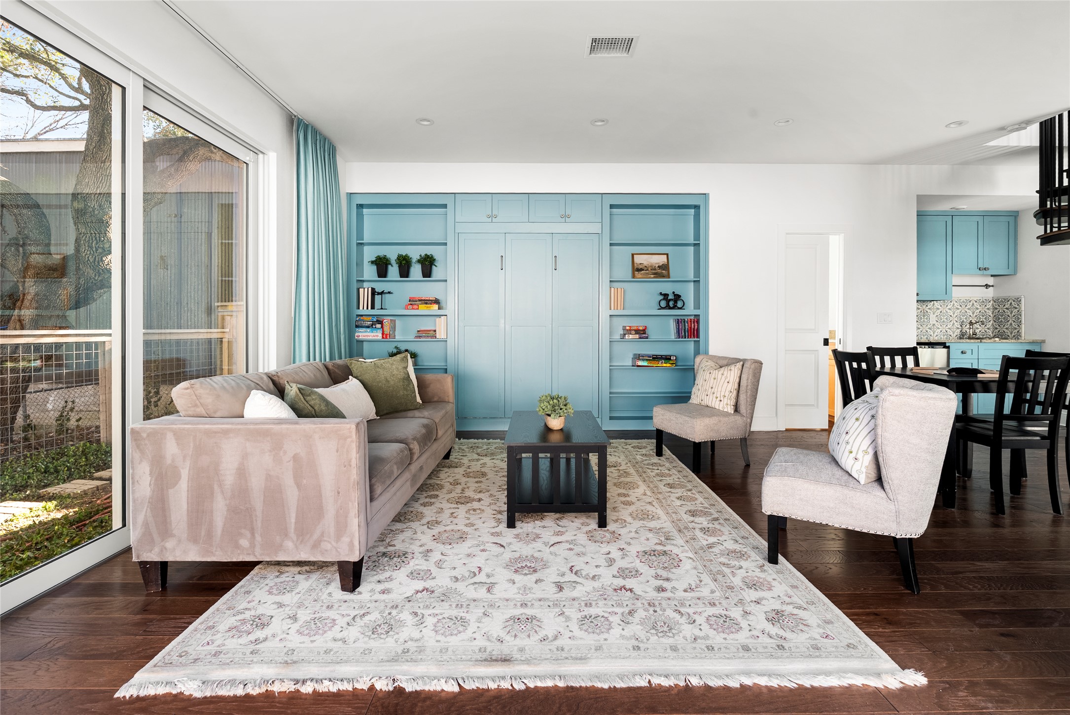 1507 Newning Avenue Austin, TX 78704 - Photo 18 of 37 family room with wood floors featuring sliding glass doors that disappear perfect for entertaining