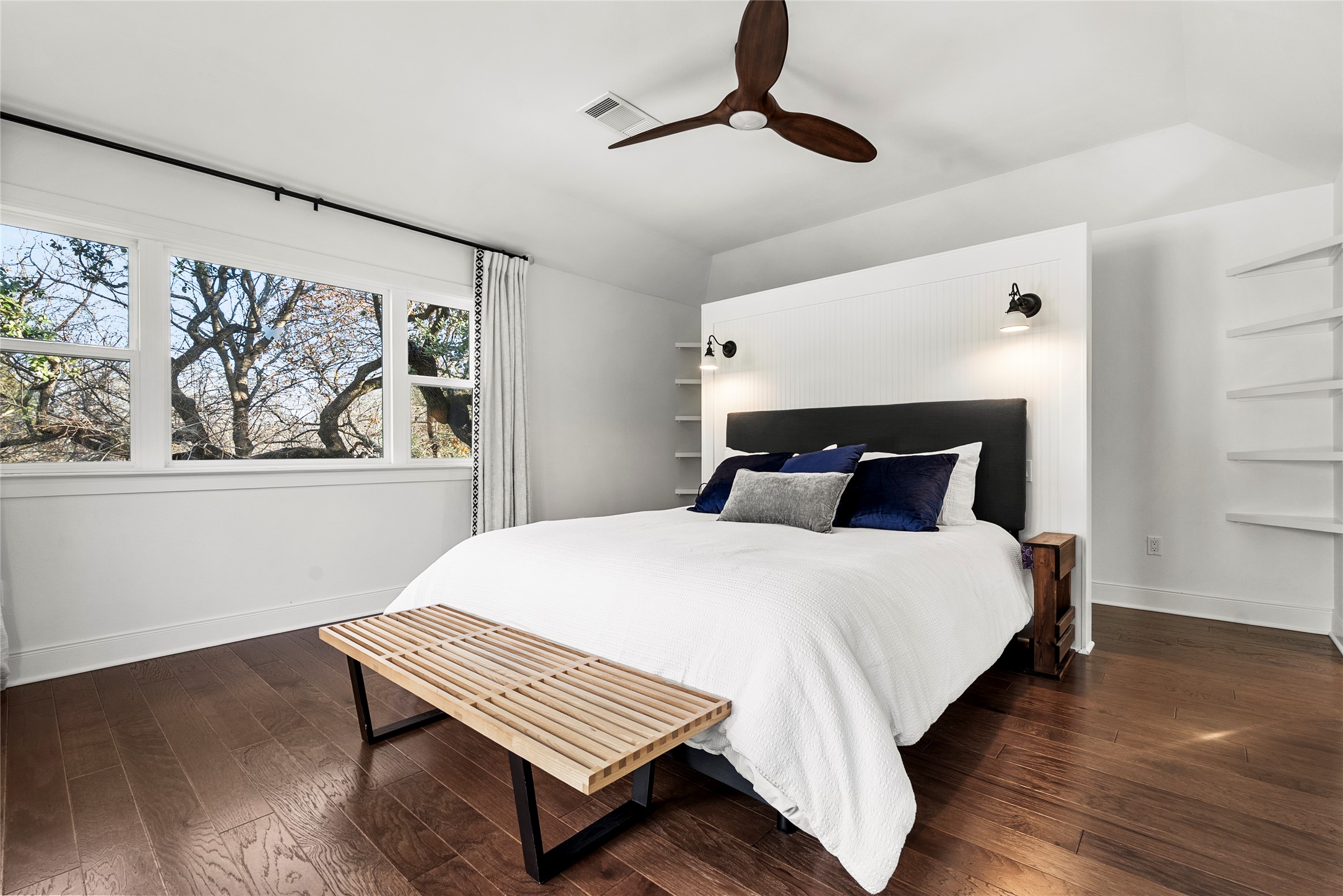 1507 Newning Avenue Austin, TX 78704 - Photo 25 of 37 Bedroom featuring wood finished floors, a ceiling fan, and view of trees