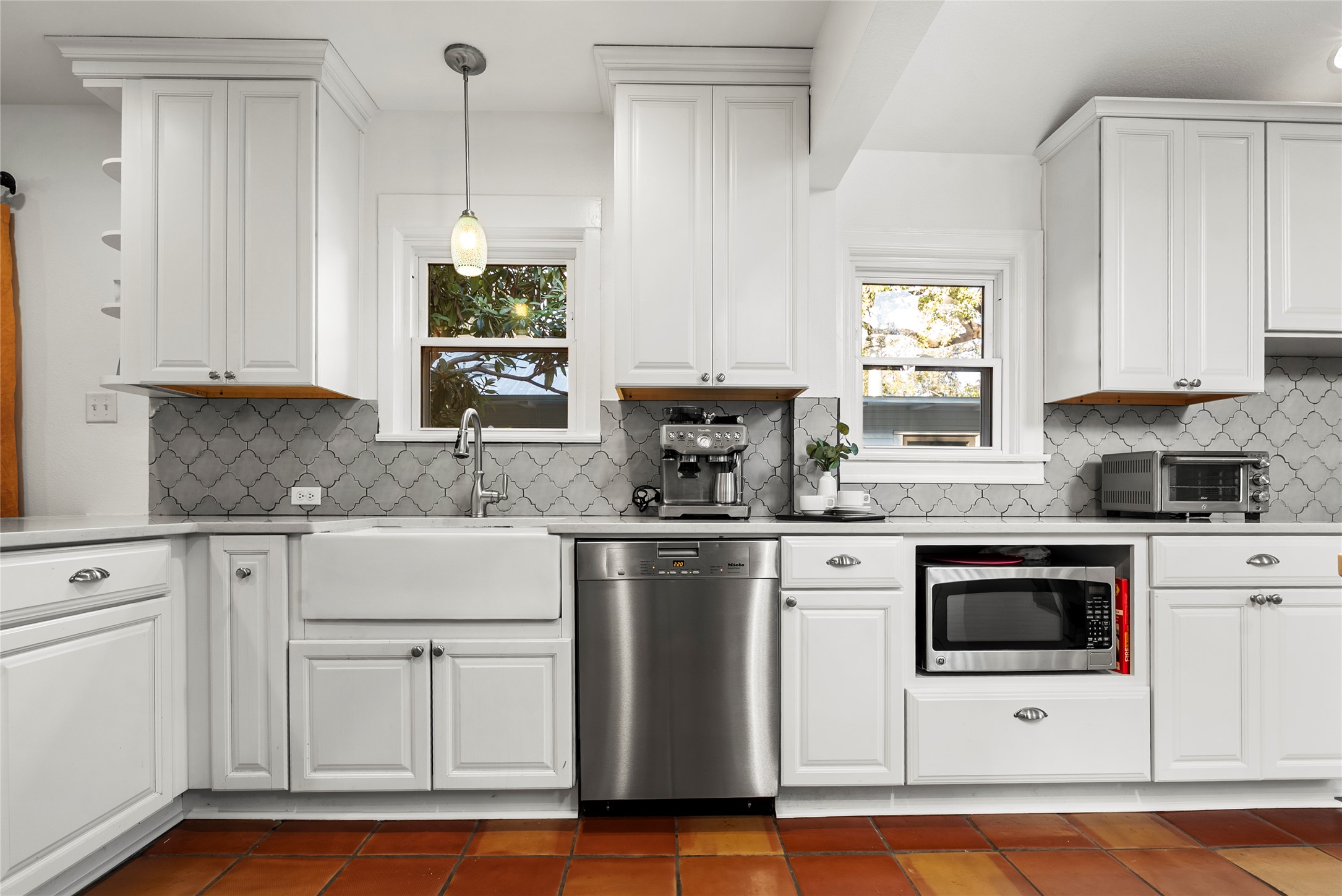 1507 Newning Avenue Austin, TX 78704 - Photo 7 of 37 Kitchen with stainless steel appliances, white cabinetry, and healthy amount of natural light