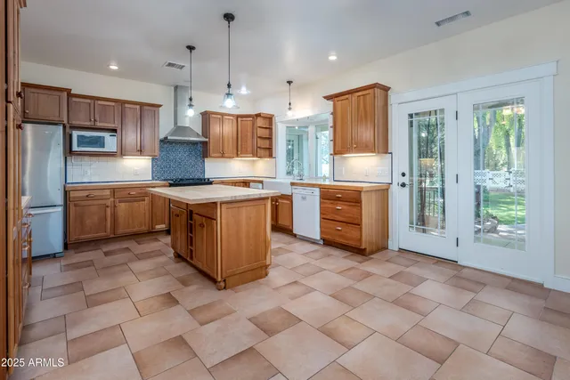 a room with a sink cabinets and a window