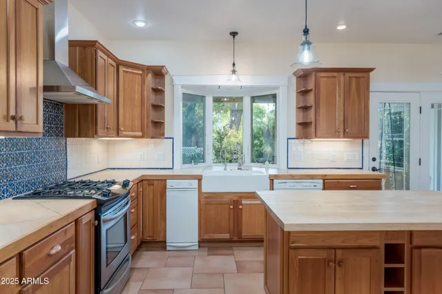 a bathroom with a tub shower sink and mirror