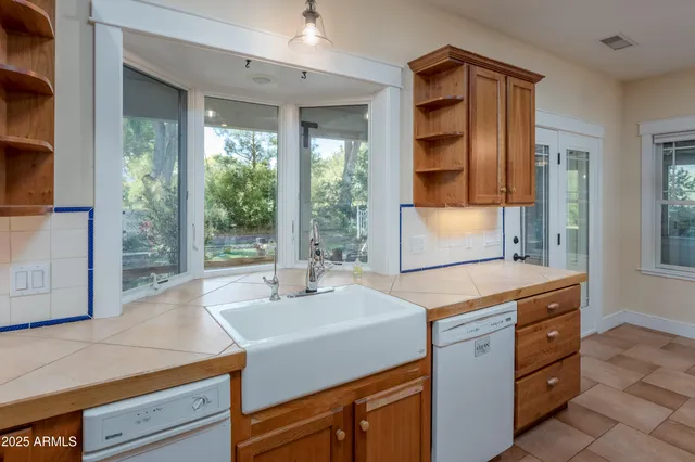 a spacious bathroom with a double vanity sink and a mirror
