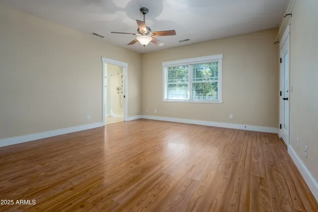 a view of a room with wooden floor