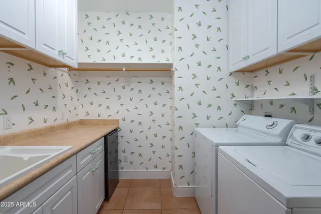 a kitchen with kitchen island a sink appliances and cabinets
