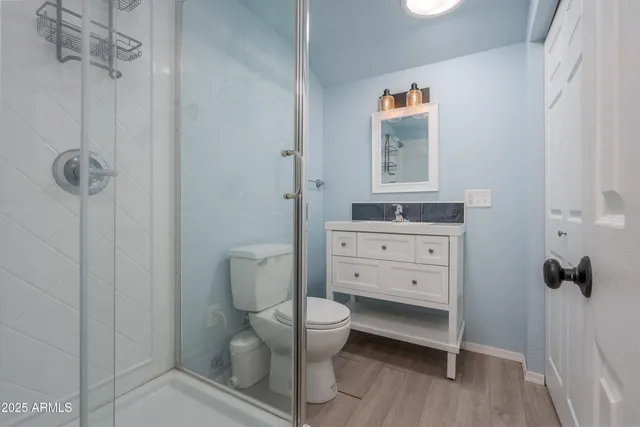 a view of a park with trees and wooden fence