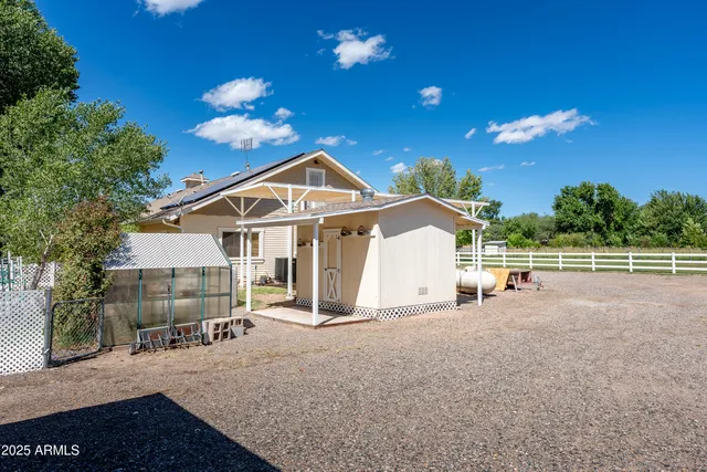 a view of a house with backyard porch and sitting area