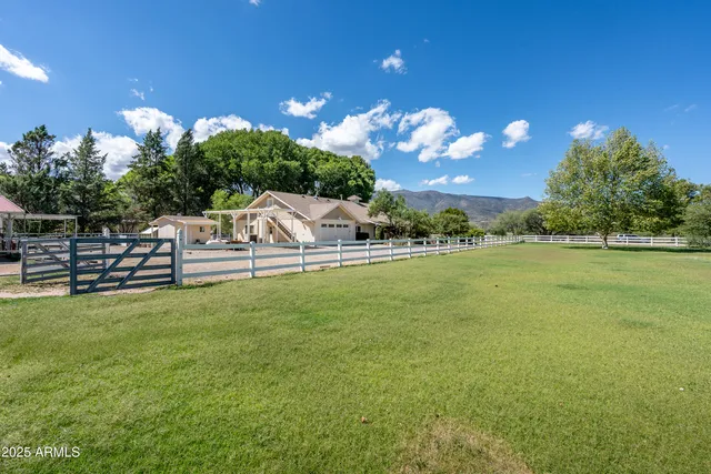 a view of a house with backyard and porch