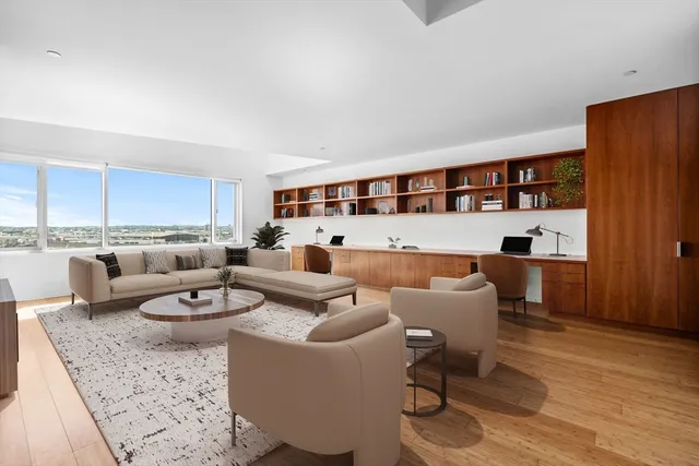 a living room with furniture and a bookshelf