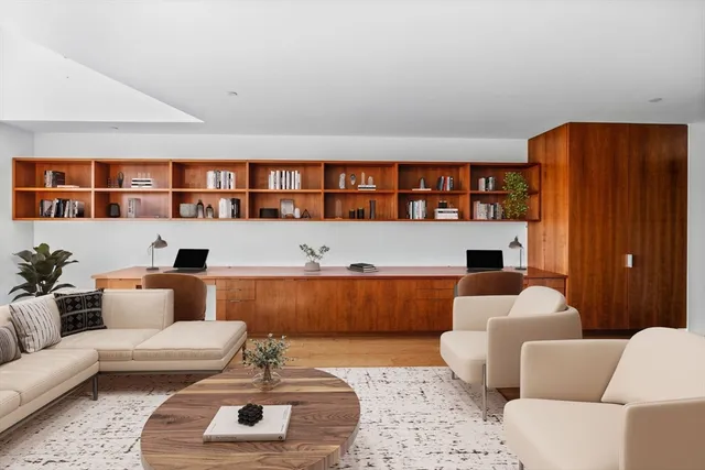 a living room with furniture wooden floor and a flat screen tv