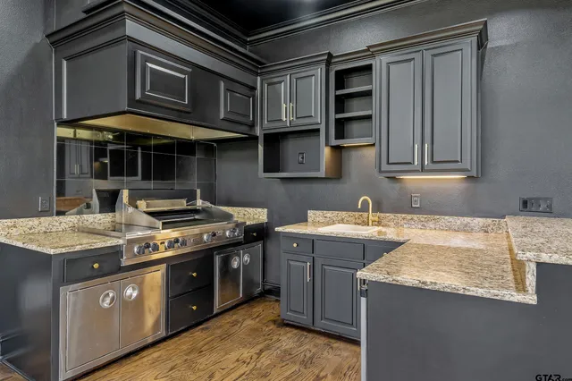 a kitchen with stainless steel appliances granite countertop a stove and a sink