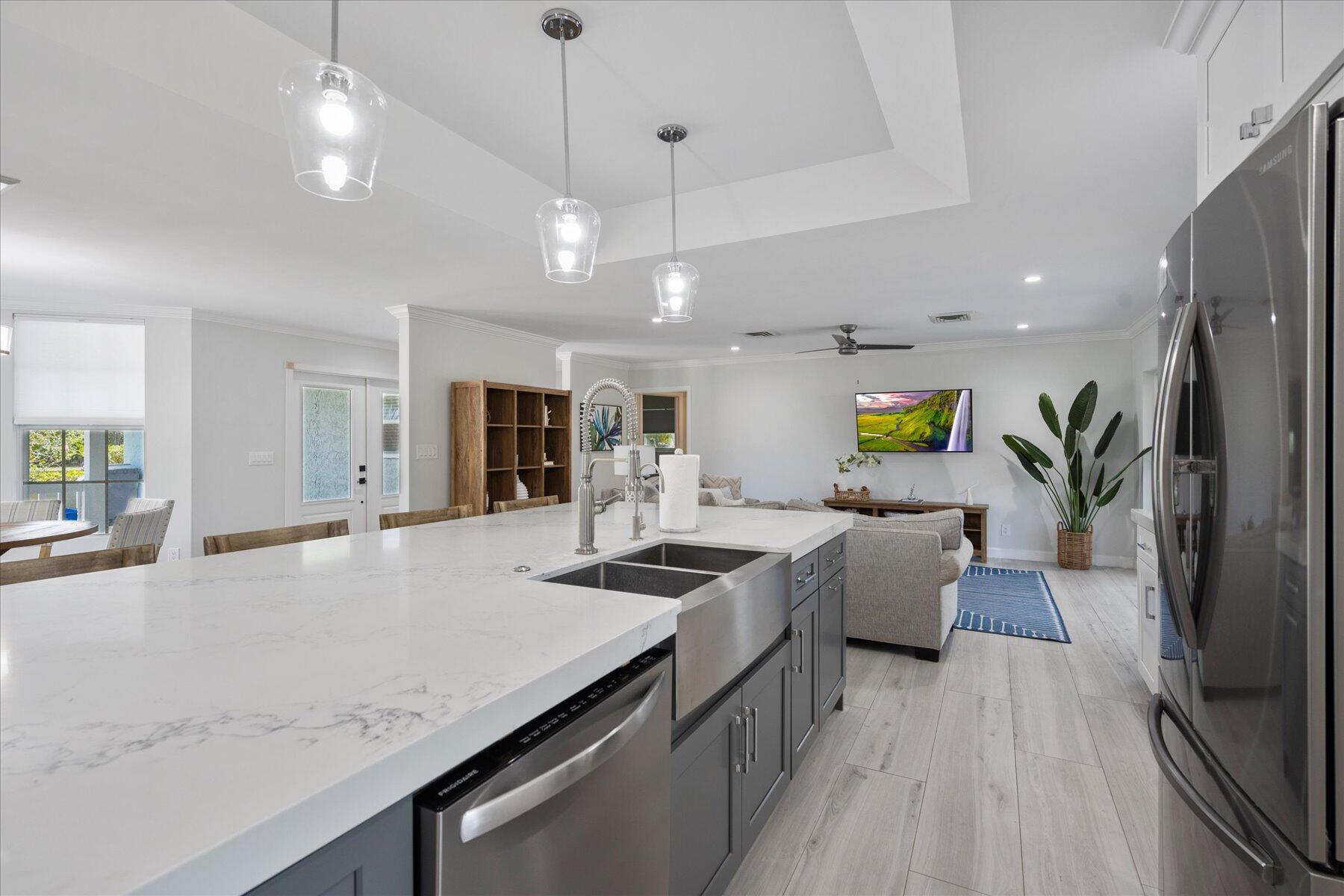 5895 Keith Road Jupiter, FL 33458 - Photo 15 of 51 a kitchen with stainless steel appliances granite countertop a stove and a view of living room