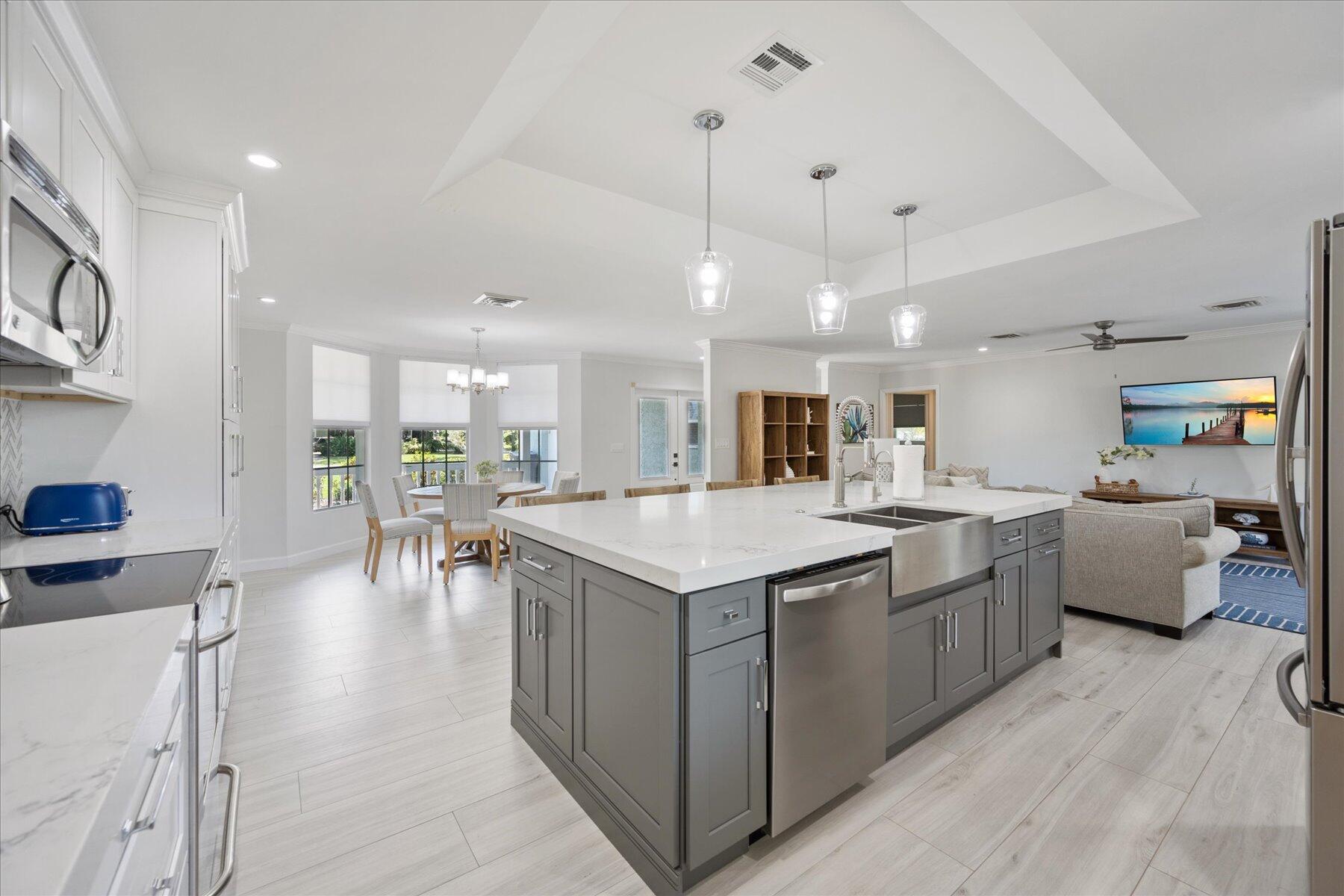 5895 Keith Road Jupiter, FL 33458 - Photo 16 of 51 a open kitchen with stainless steel appliances granite countertop lots of counter top space and furniture