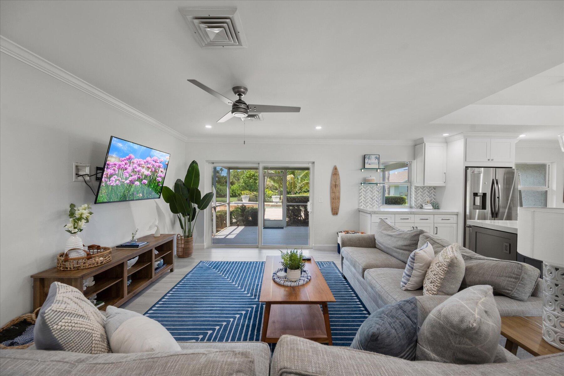 5895 Keith Road Jupiter, FL 33458 - Photo 17 of 51 a living room with furniture and a flat screen tv