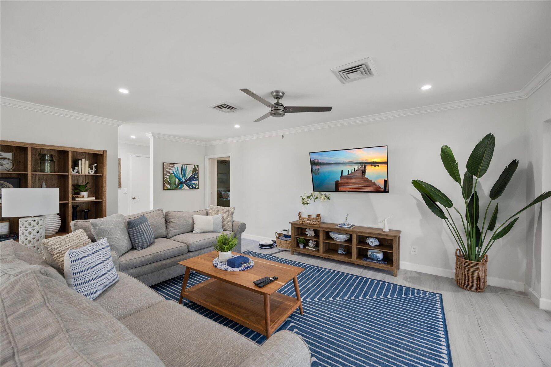5895 Keith Road Jupiter, FL 33458 - Photo 19 of 51 a living room with furniture a table and a potted plant