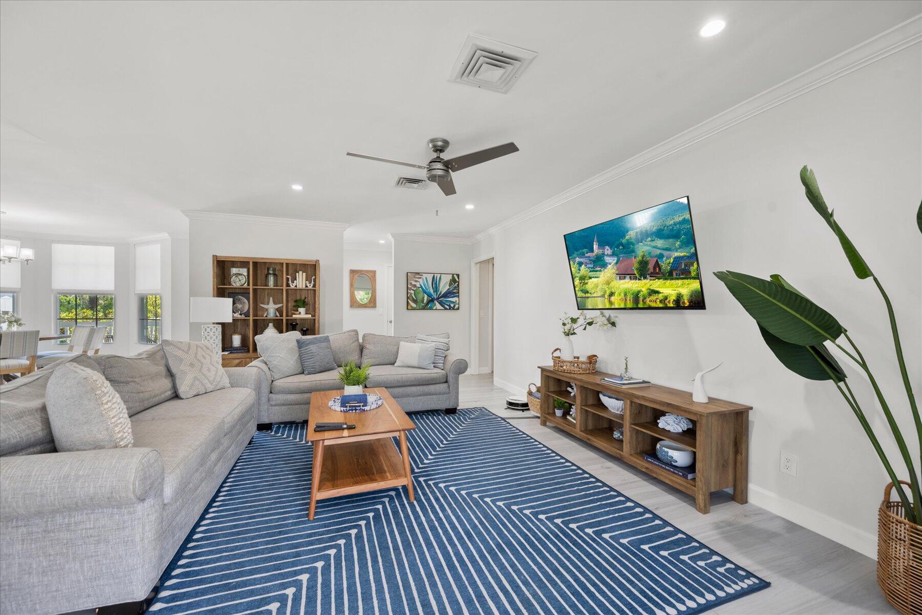 5895 Keith Road Jupiter, FL 33458 - Photo 20 of 51 a living room with furniture and a wooden floor