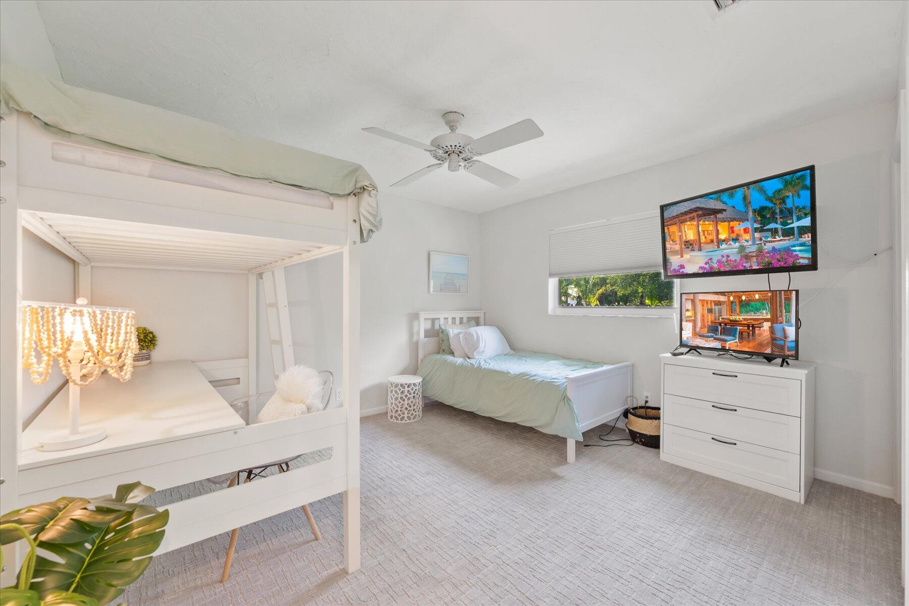 5895 Keith Road Jupiter, FL 33458 - Photo 21 of 51 a living room with furniture and a flat screen tv