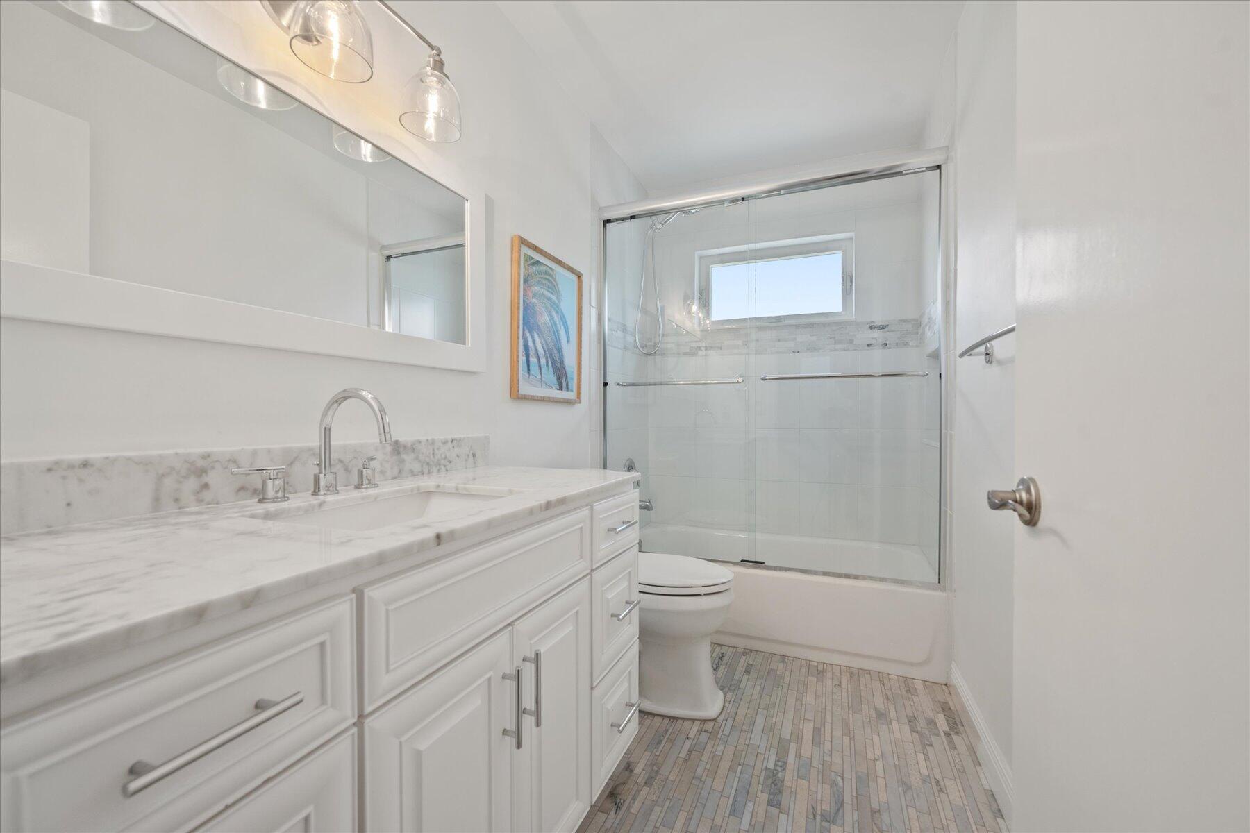 5895 Keith Road Jupiter, FL 33458 - Photo 22 of 51 a bathroom with a granite countertop sink toilet and shower