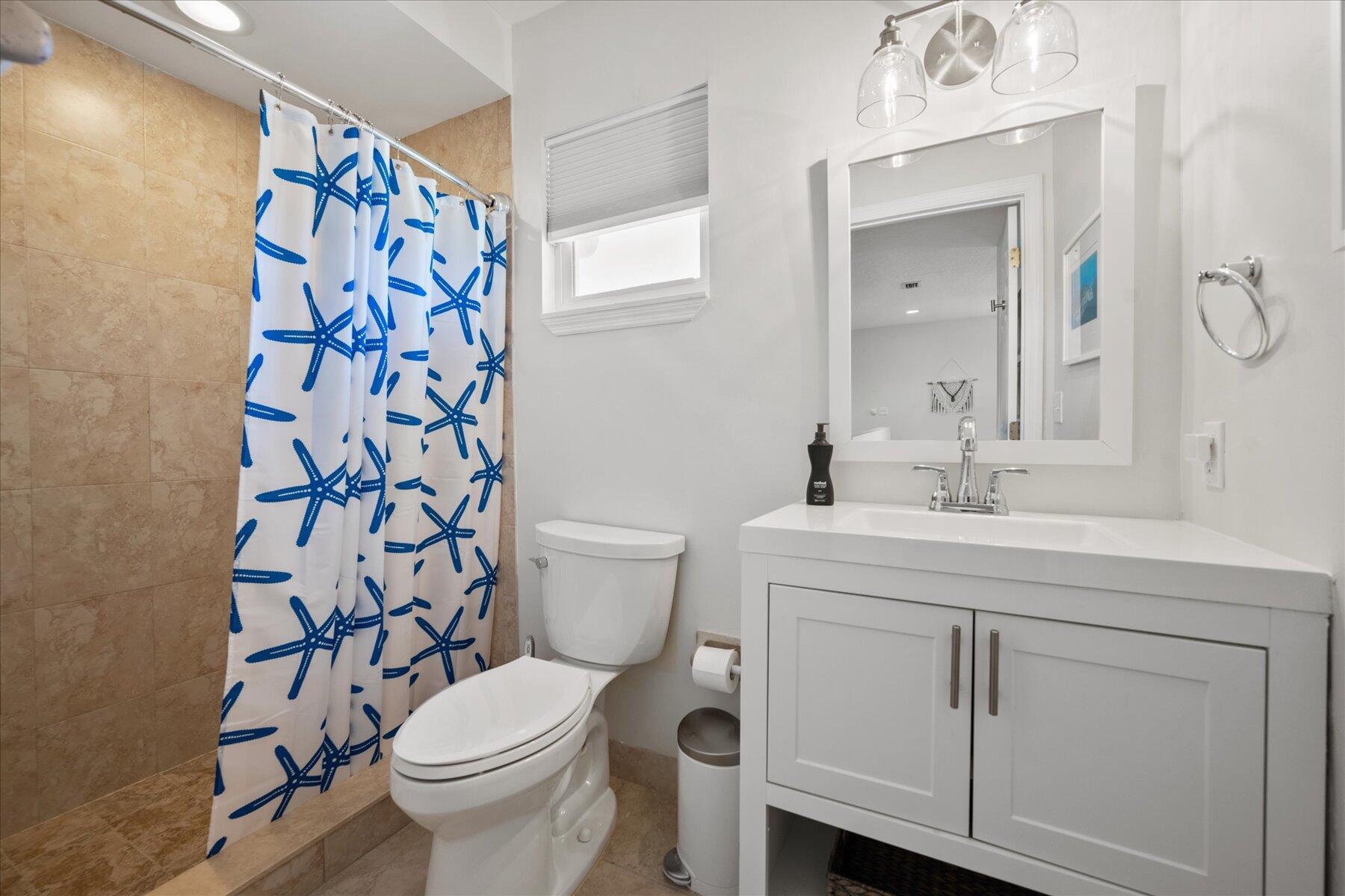 5895 Keith Road Jupiter, FL 33458 - Photo 32 of 51 a bathroom with a toilet sink and mirror