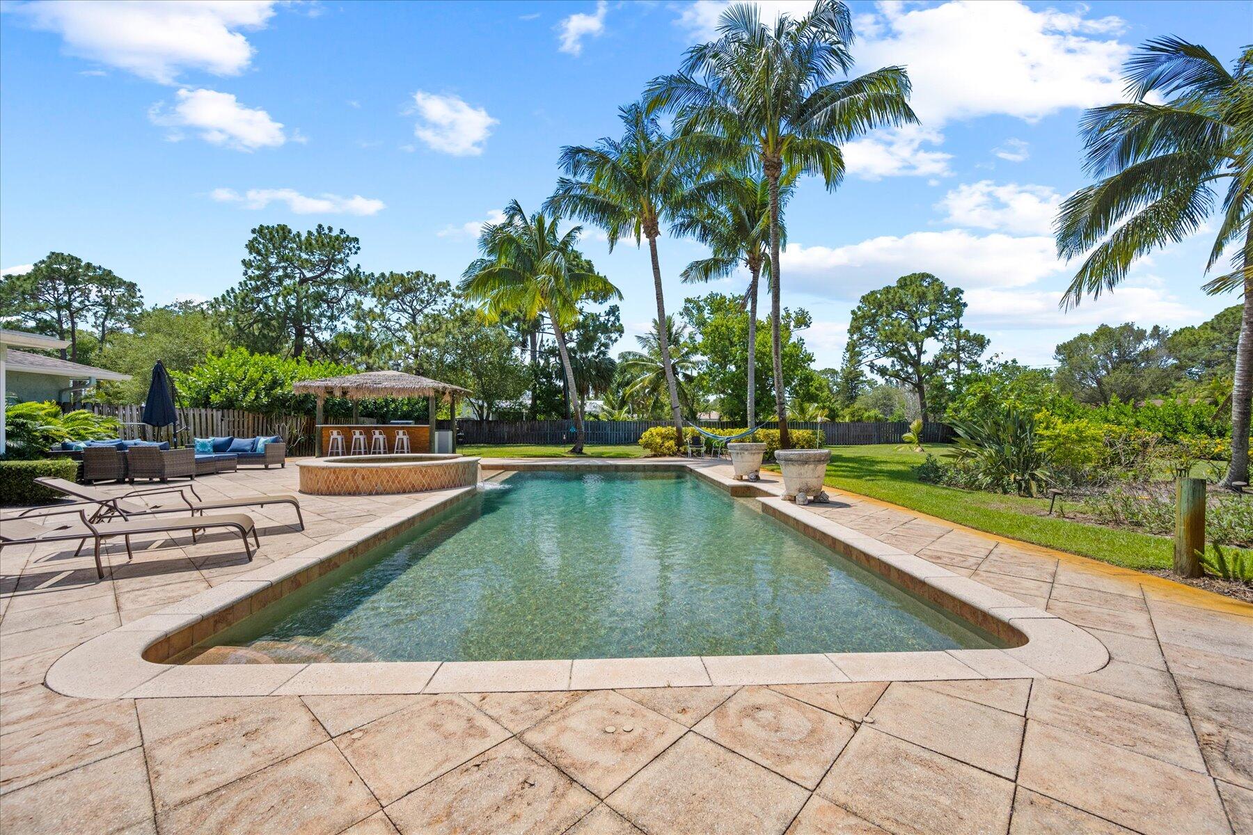 5895 Keith Road Jupiter, FL 33458 - Photo 42 of 51 a view of swimming pool with outdoor seating and plants