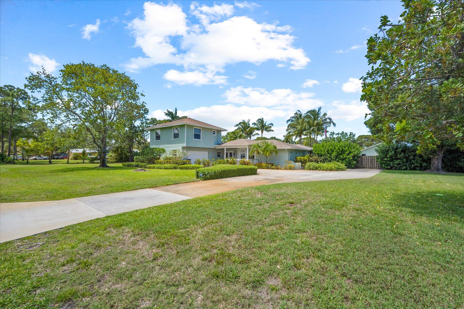 5895 Keith Road Jupiter, FL 33458 - Photo 45 of 51 a view of building with garden