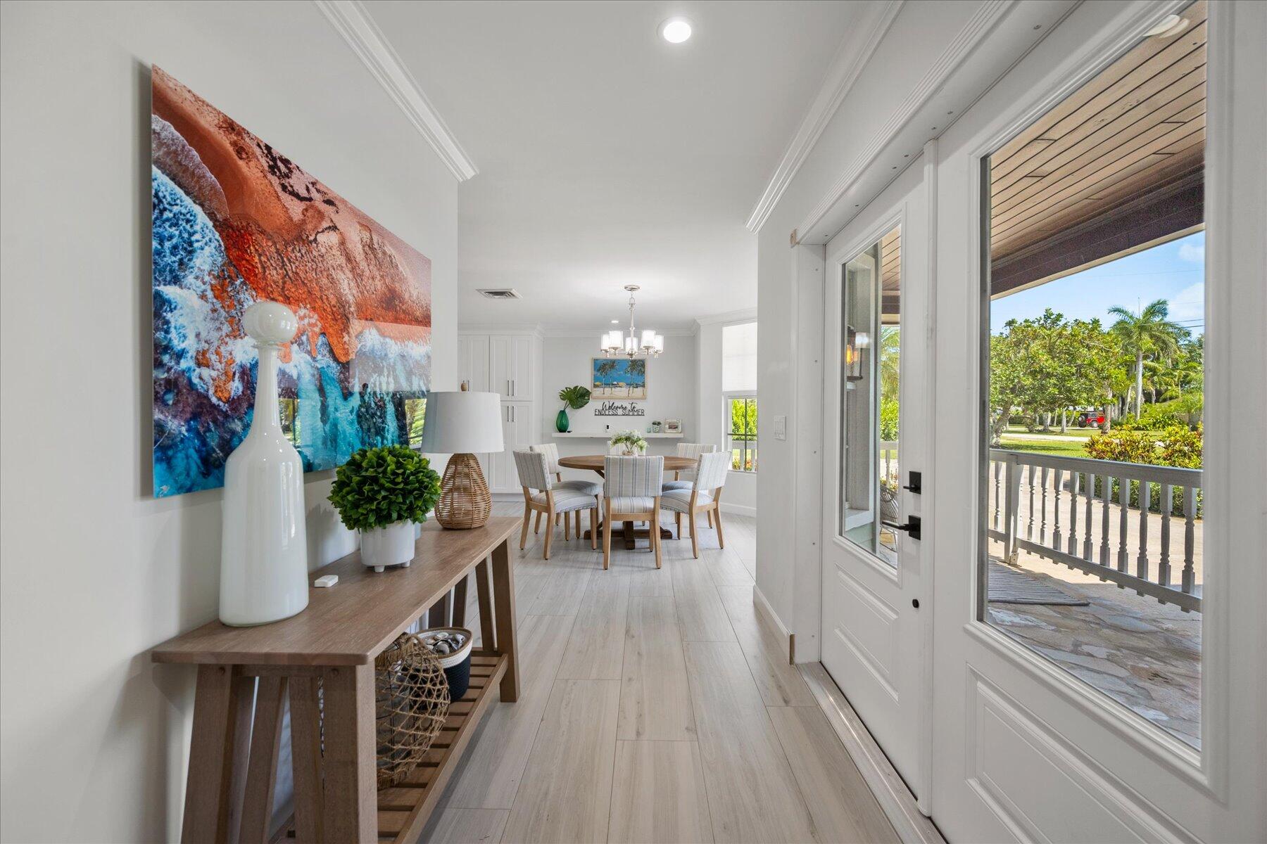 5895 Keith Road Jupiter, FL 33458 - Photo 8 of 51 a view of a dining room with furniture window and wooden floor