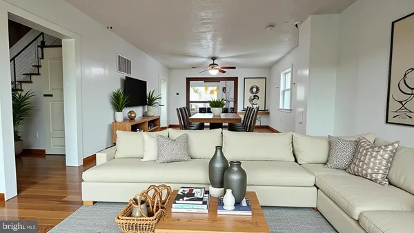 a living room with furniture a flat screen tv and a chandelier
