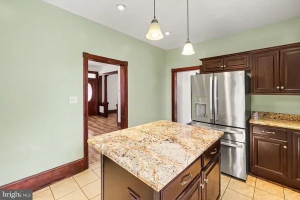 a kitchen with granite countertop cabinets and refrigerator