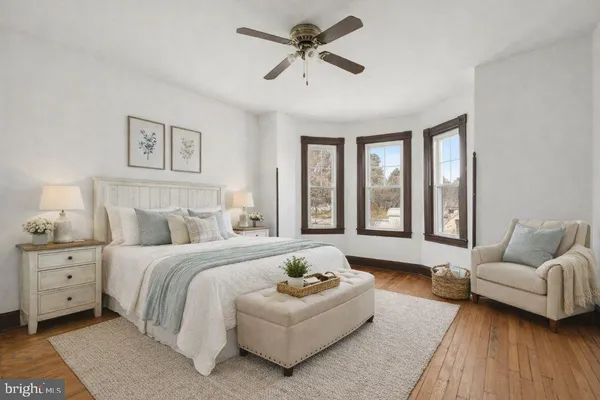 a spacious bedroom with a bed and a couch