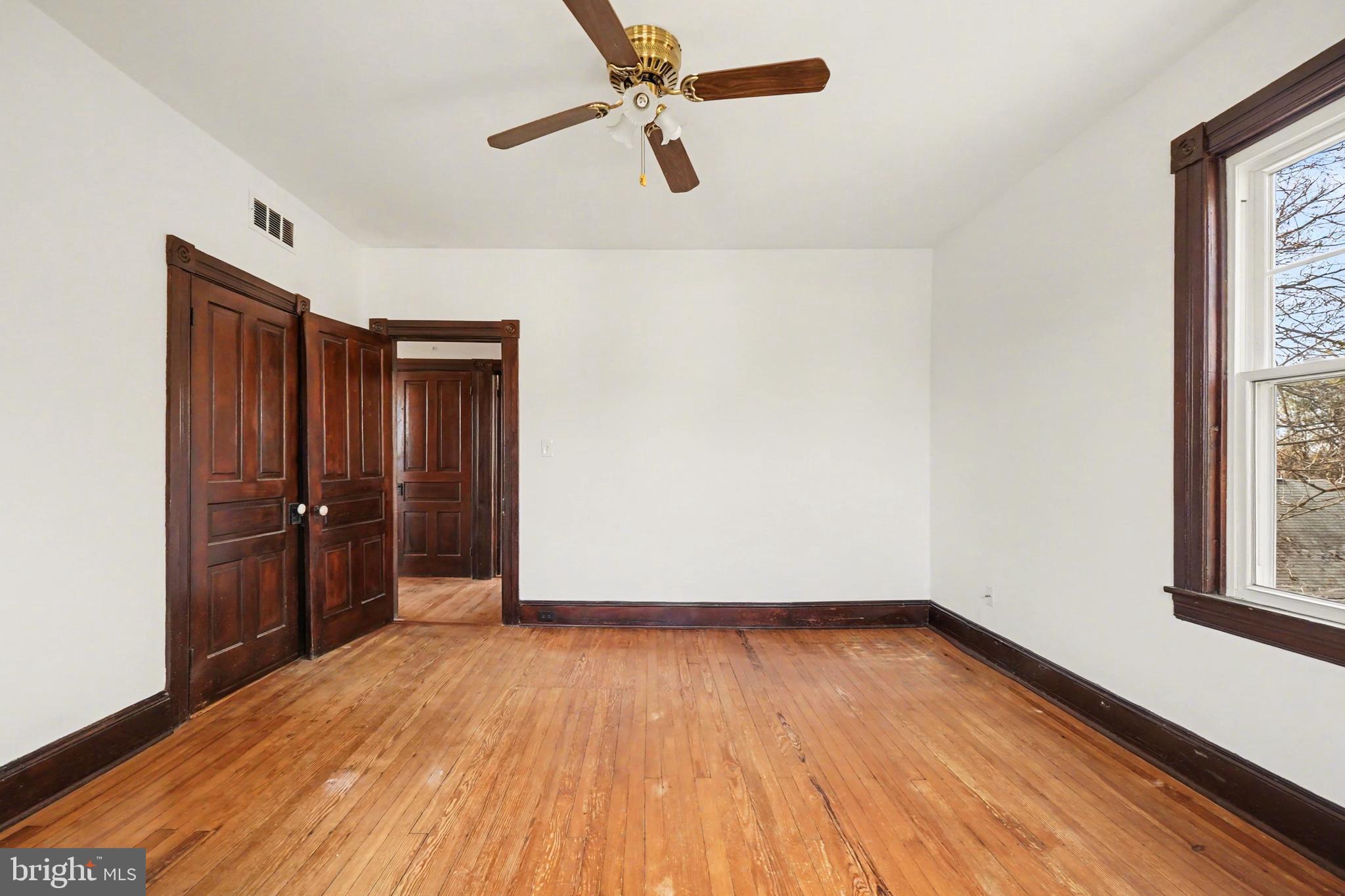 2322 Rock Spring Road Forest Hill, MD 21050 - Photo 26 of 39 an empty room with wooden floor cabinet and windows