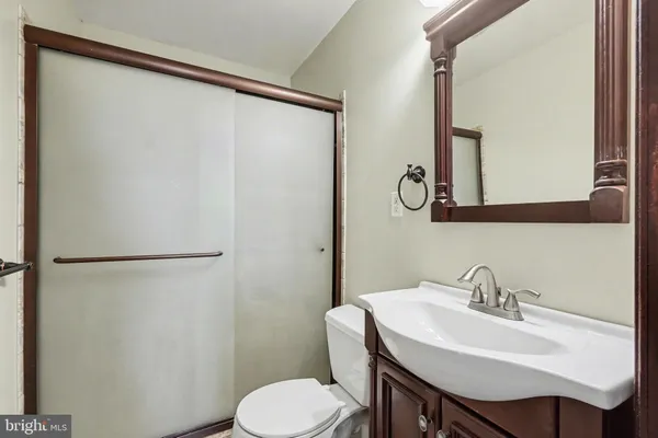 a bathroom with a sink toilet and mirror