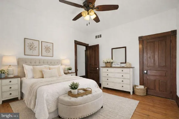 a bedroom with a bed and a dresser